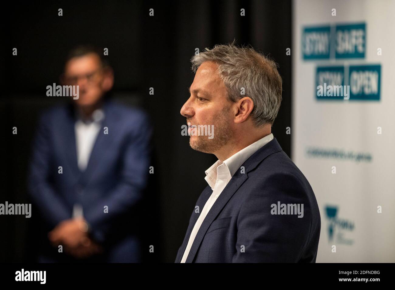 Premier Daniel Andrews Looks On While Chief Health Officer Brett Sutton Speaks At A Press Conference
