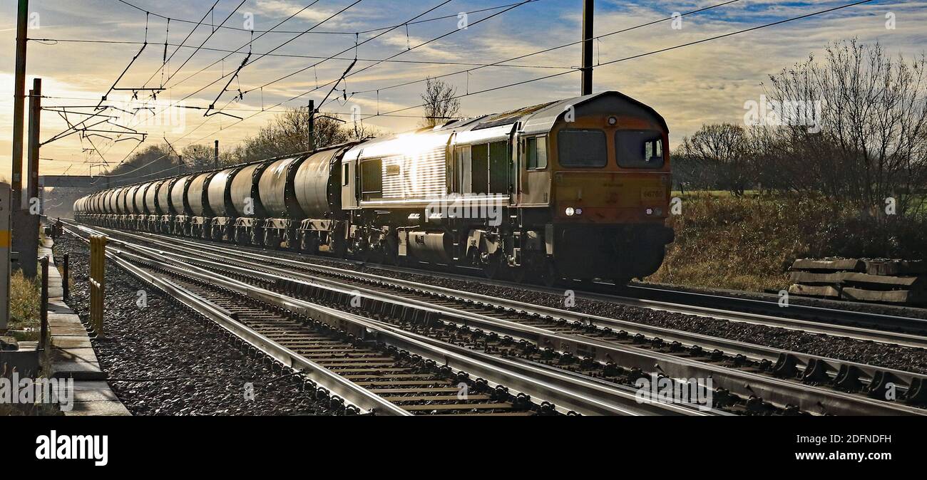 GBRF Diesel locomotive 66760 passes Balshaw Lane near Euxton on a sunny winter’s day with an empty cement train going for reloading in Clitheroe. Stock Photo