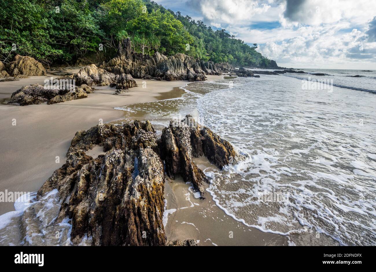 rock outcrops at the secluded beach of rainforest surrounded Etty Bay near Innisfail, North Queensland, Australia Stock Photo