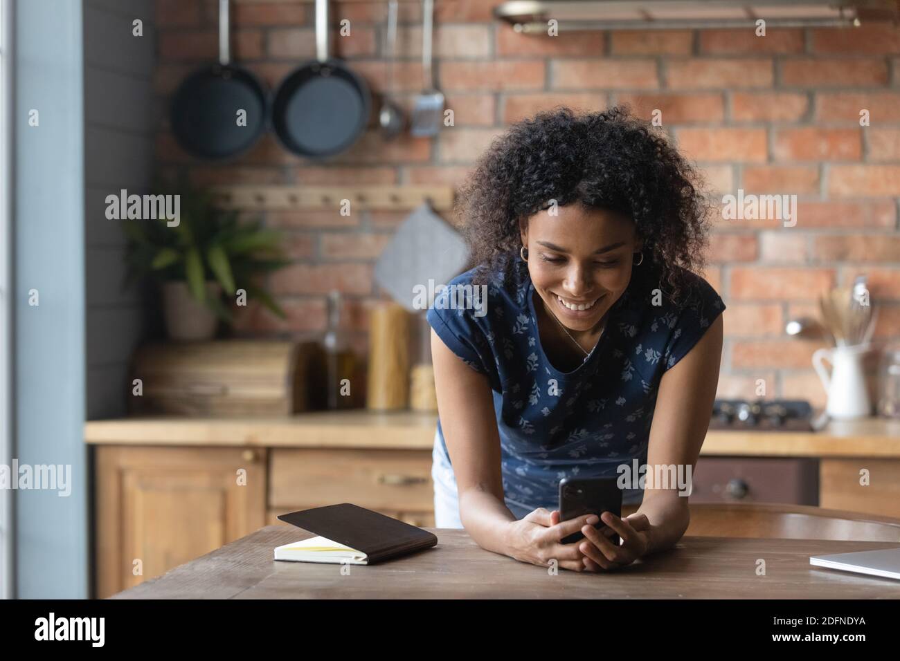 Addicted to technology young biracial lady using cellphone application. Stock Photo