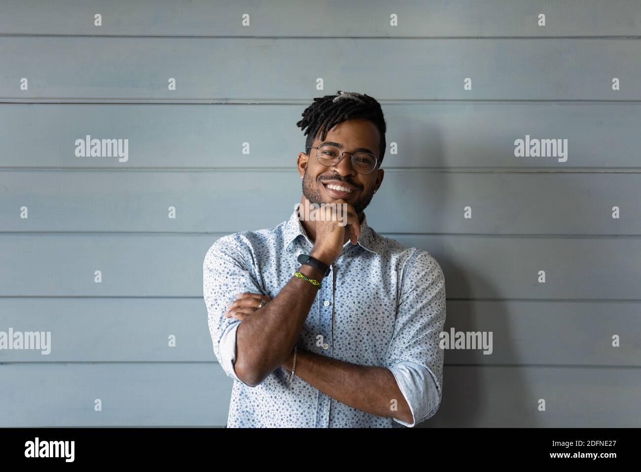 Happy young confident african american man on wall background. Stock Photo