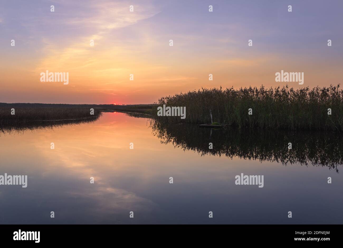 Scenic sunset landscape with water reflections and mood colors at autumn evening in Finland. Stock Photo
