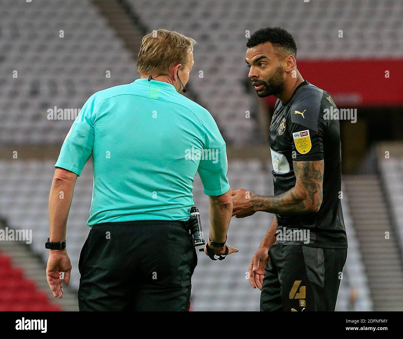 Curtis Tilt 4 of Wigan Athletic speaks with referee Trevor Kettle