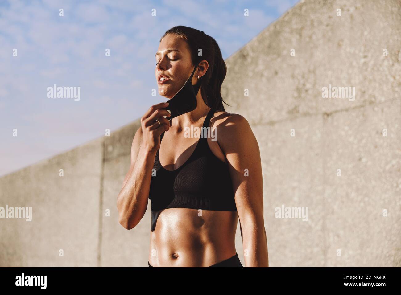 Woman taking a break after work taking off the face mask. Fitness woman feeling tired after exercising in morning Stock Photo Alamy