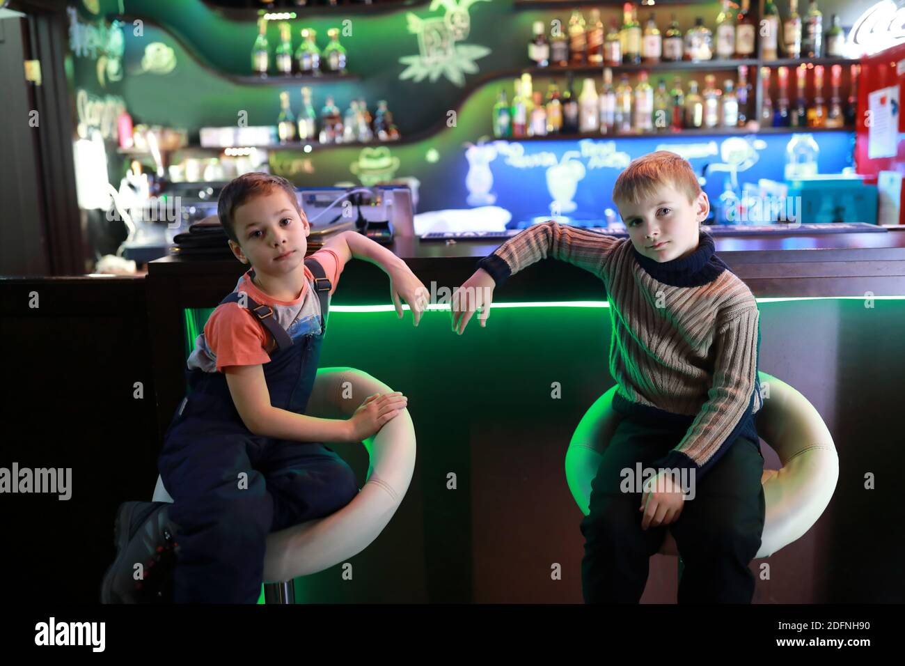 Children sitting at bar in a restaurant Stock Photo Alamy