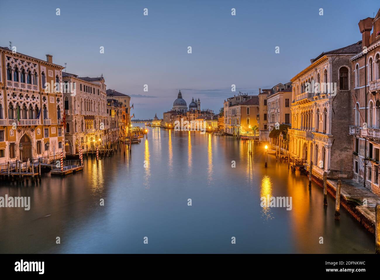 The Grand Canal and the Basilica Di Santa Maria Della Salute in Venice before sunrise Stock Photo