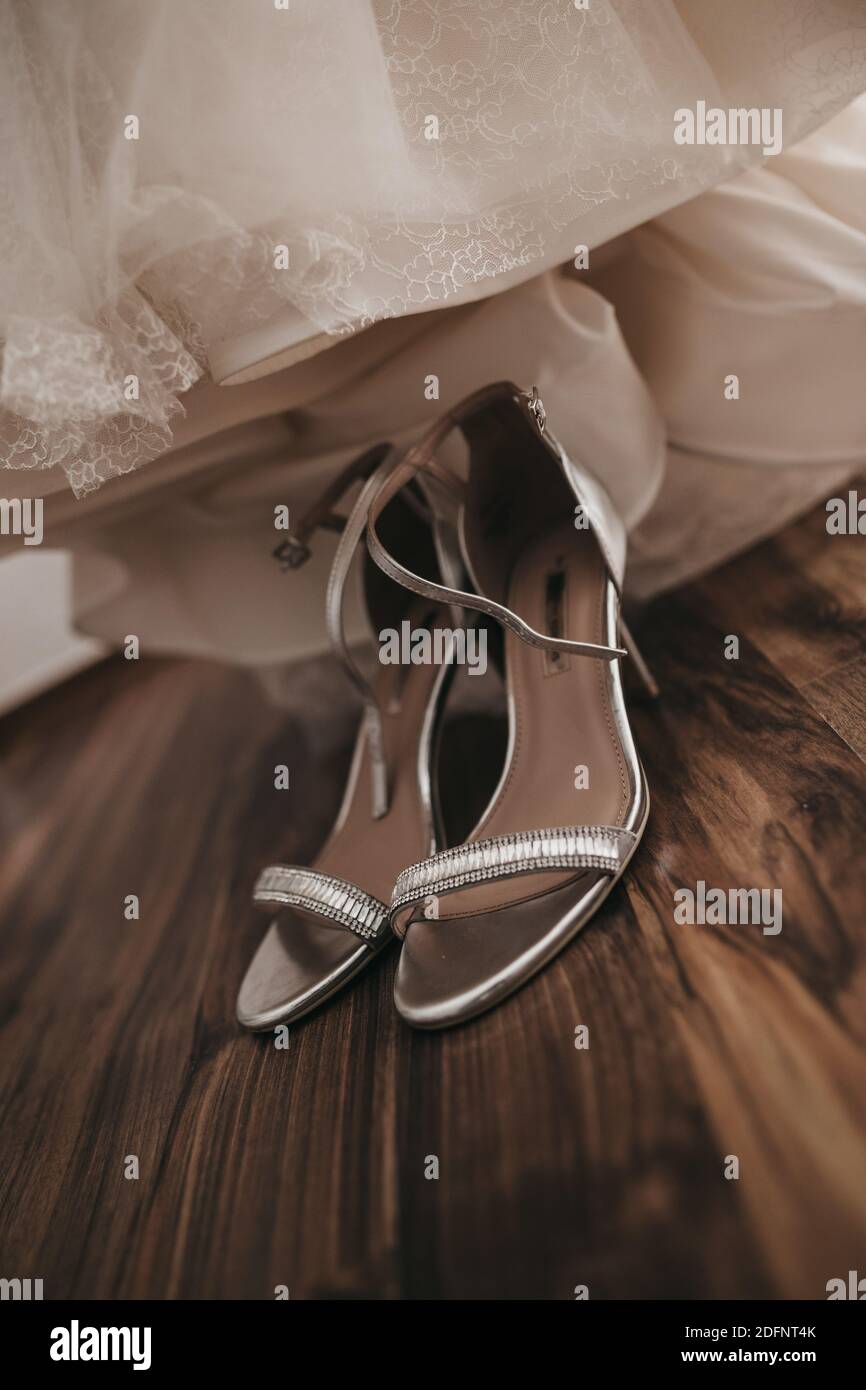 A vertical closeup shot of a pair of bridal wedding shoes Stock Photo