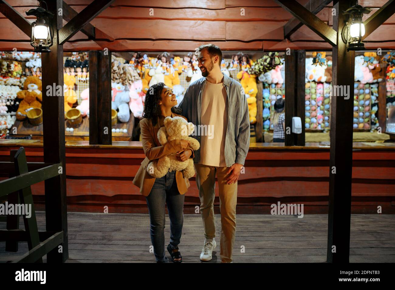 Love couple in amusement park shooting gallery Stock Photo