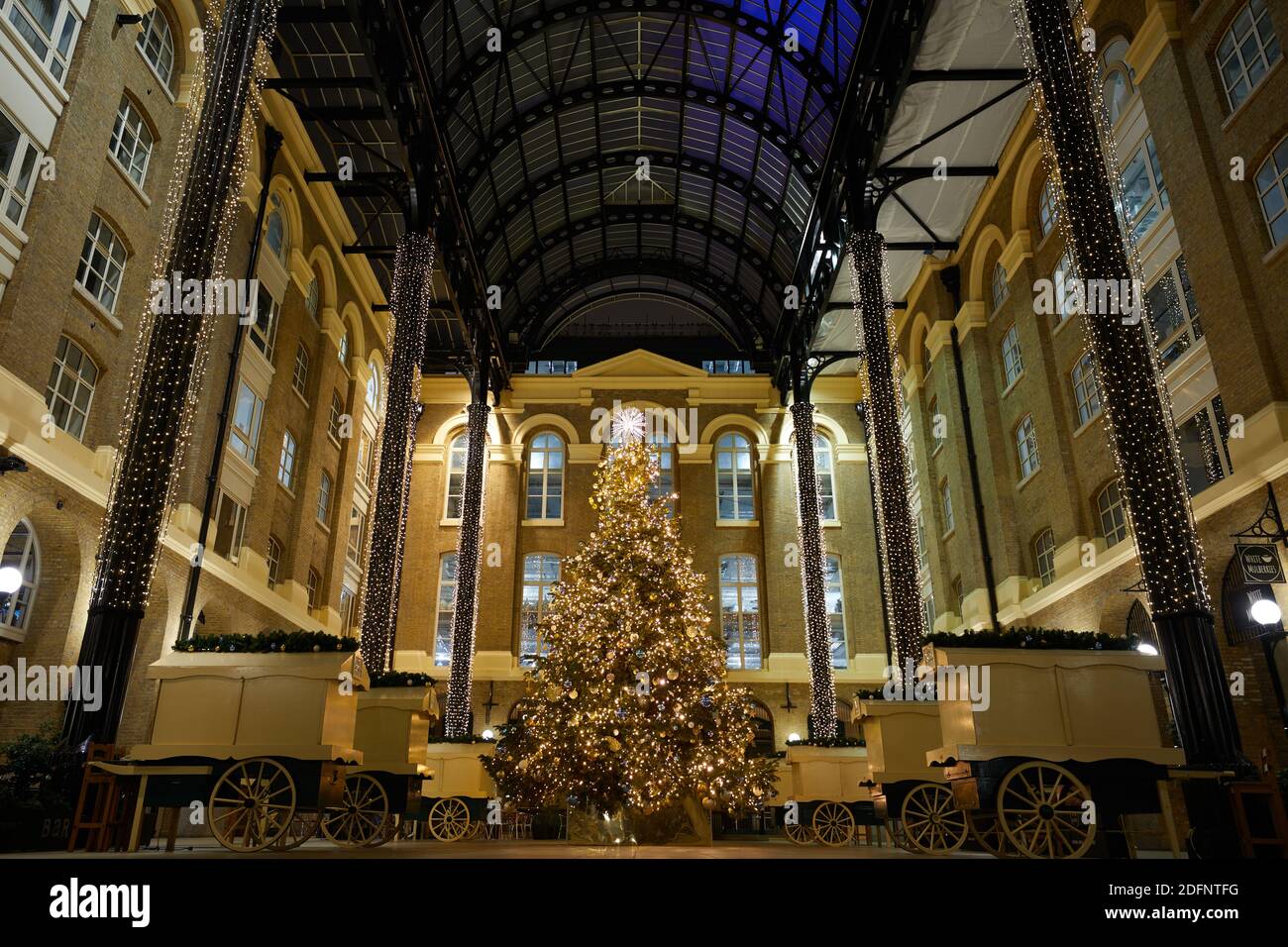 London, UK. - 6 Dec 2020: Hay's Galleria, a commerical and retail area near London Bridge, is decorated in festive lights and tree for Christmas 2020. Stock Photo