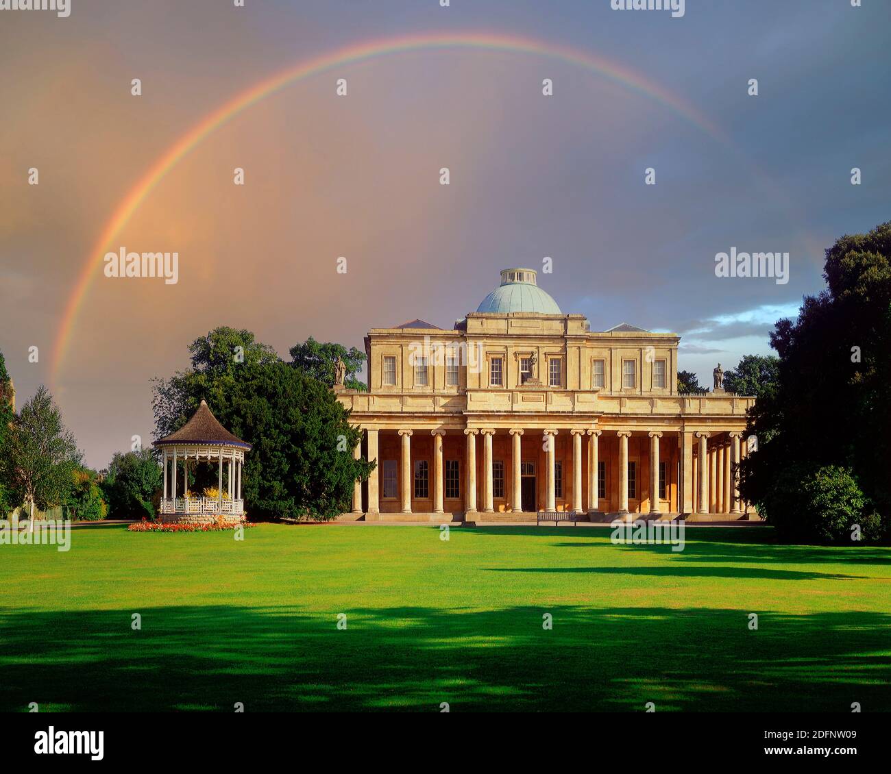 GB - GLOUCESTERSHIRE: Rainbow over the magnificent Regency Pump Rooms in Pittville Park, Cheltenham Stock Photo