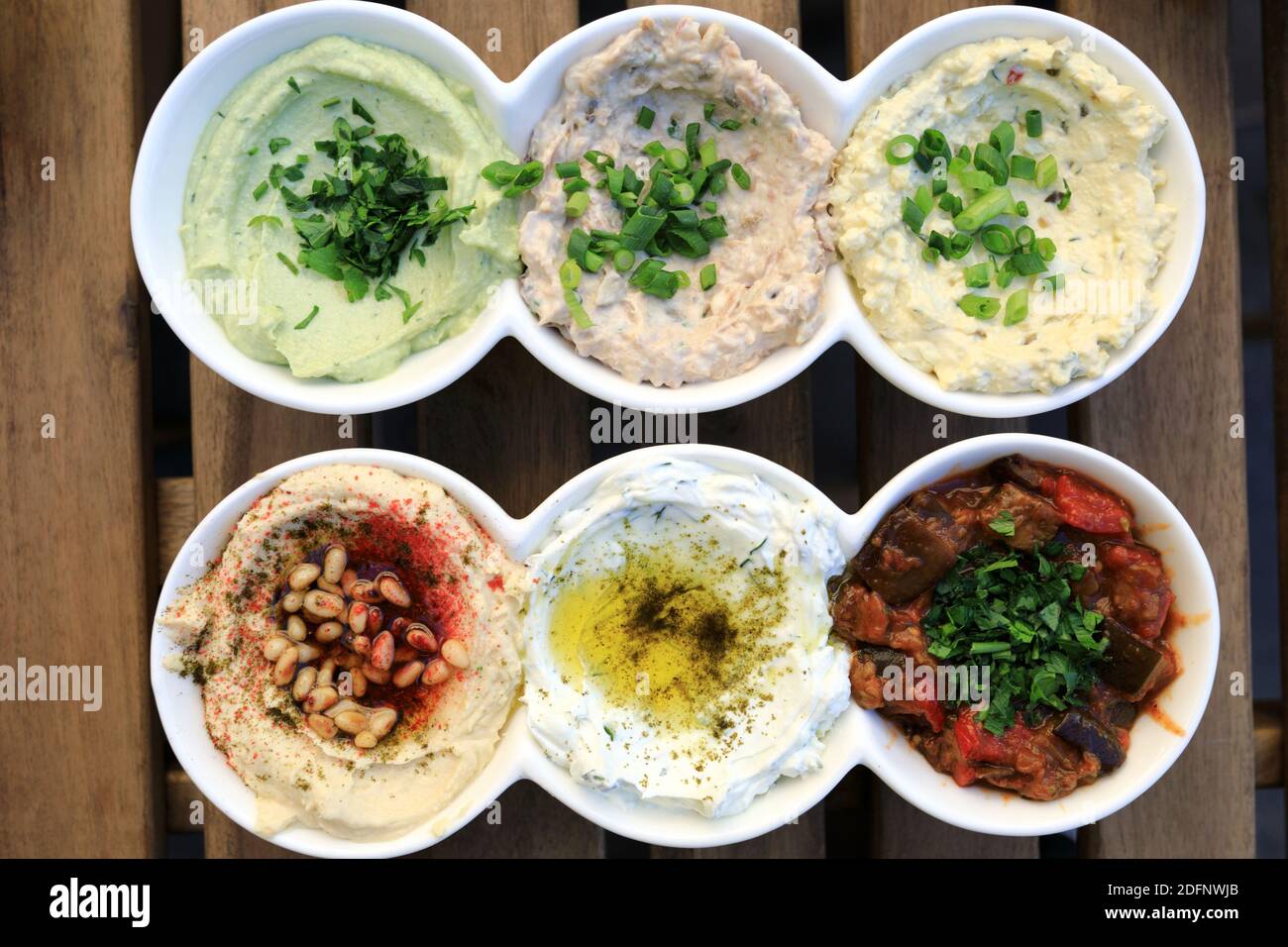 Israeli snack set matbucha with eggplant, labneh with zaatar, hummus