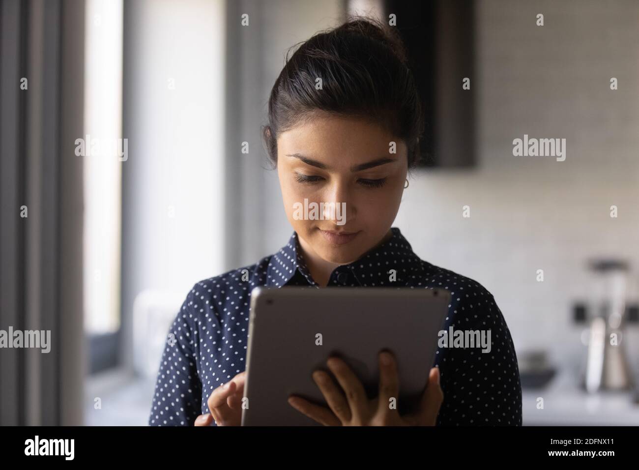 Concentrated hindu female use electronic tablet chatting in social