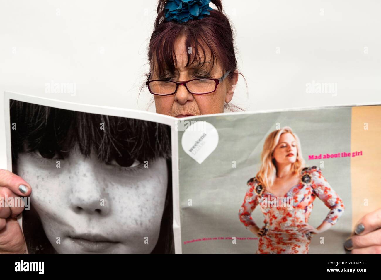 Woman reading The Guardian Weekend magazine Stock Photo
