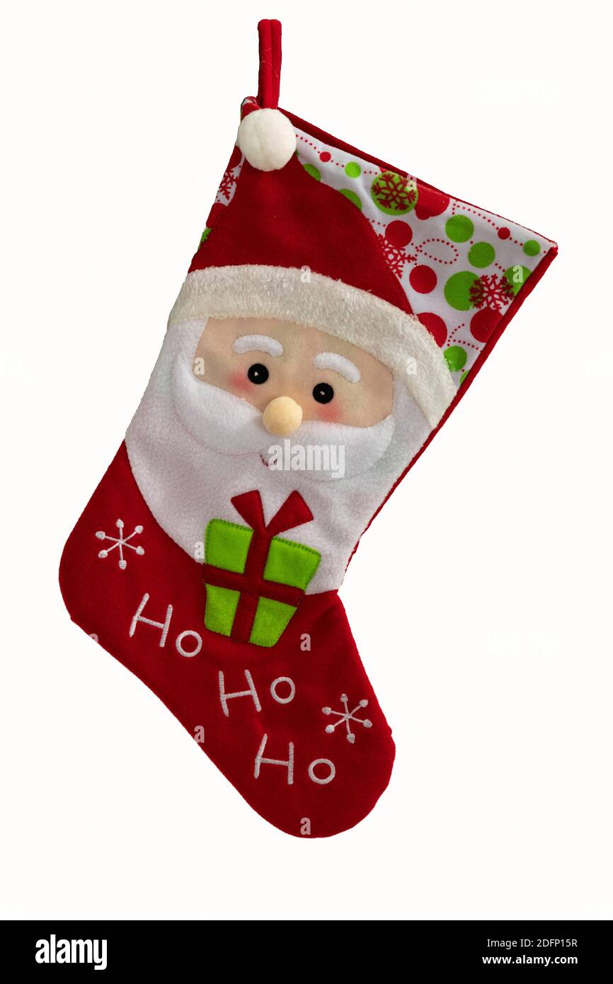 A beautiful Red empty Christmas stocking with santa face on it and on a white background. Stock Photo