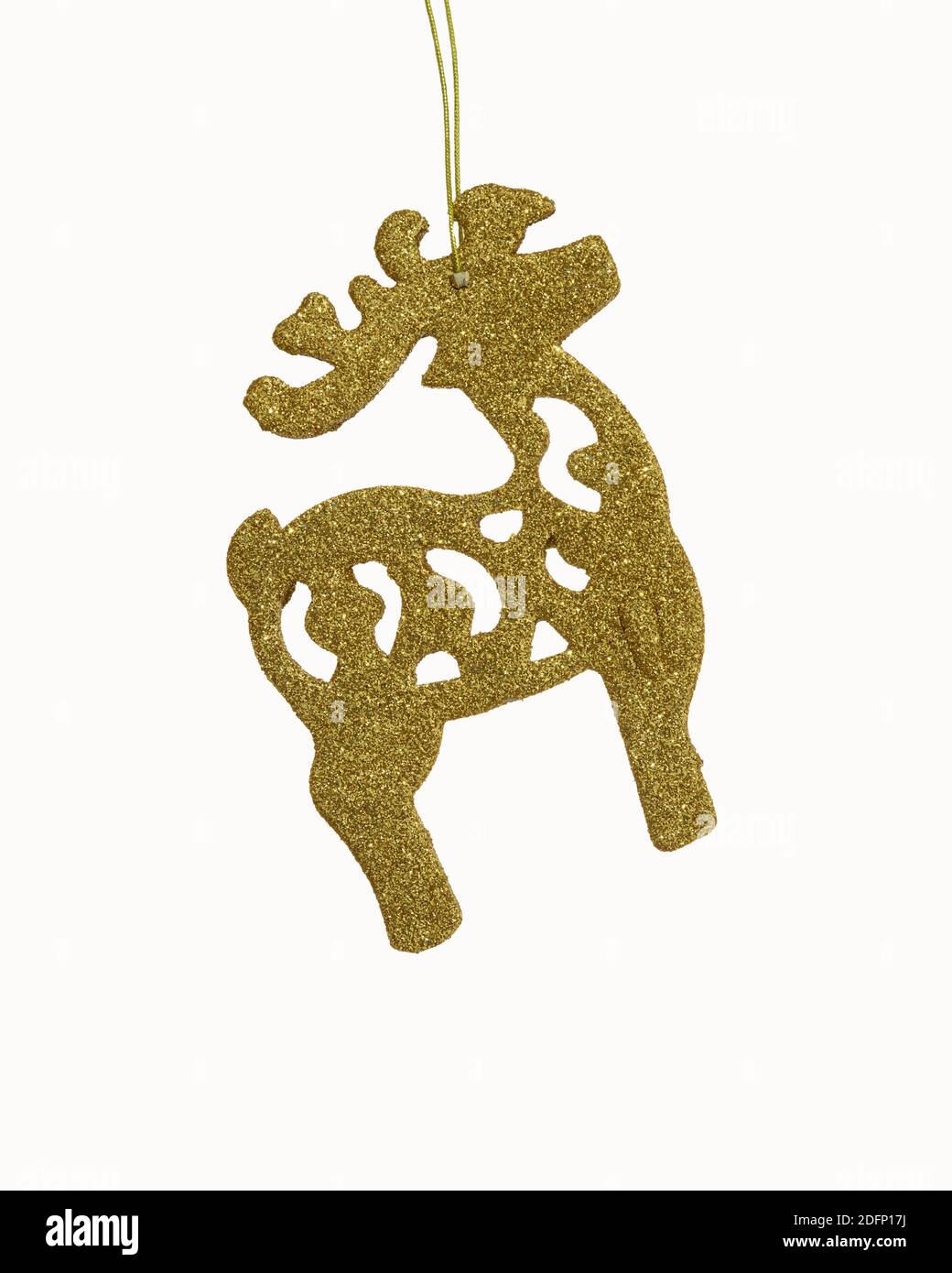 A golden colored Reindeer shaped artwork used for decorating a Christmas tree or within the house. Stock Photo