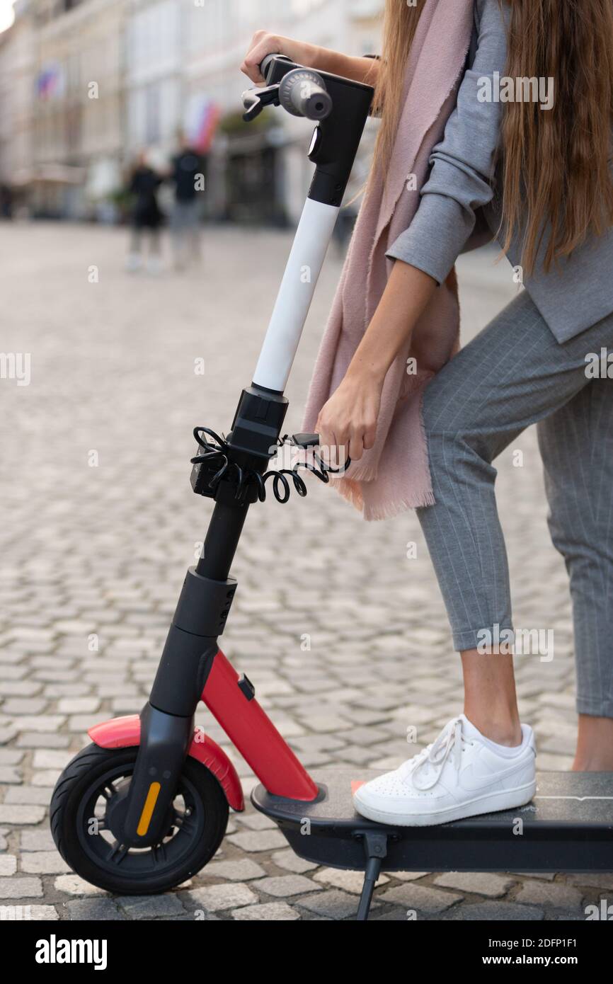 User unlocking rental electric scooter. Eco friendly green modern urban