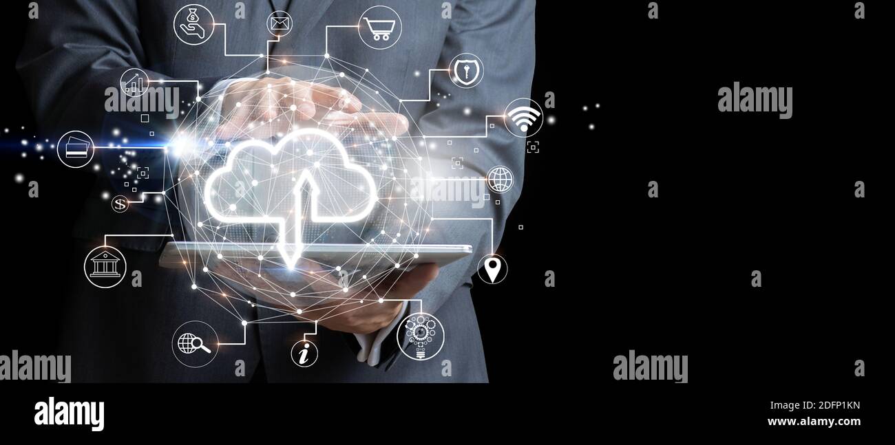 Businessman with tablet using Cloud computing. Futuristic display technology and connectivity concept. Mixed media Stock Photo