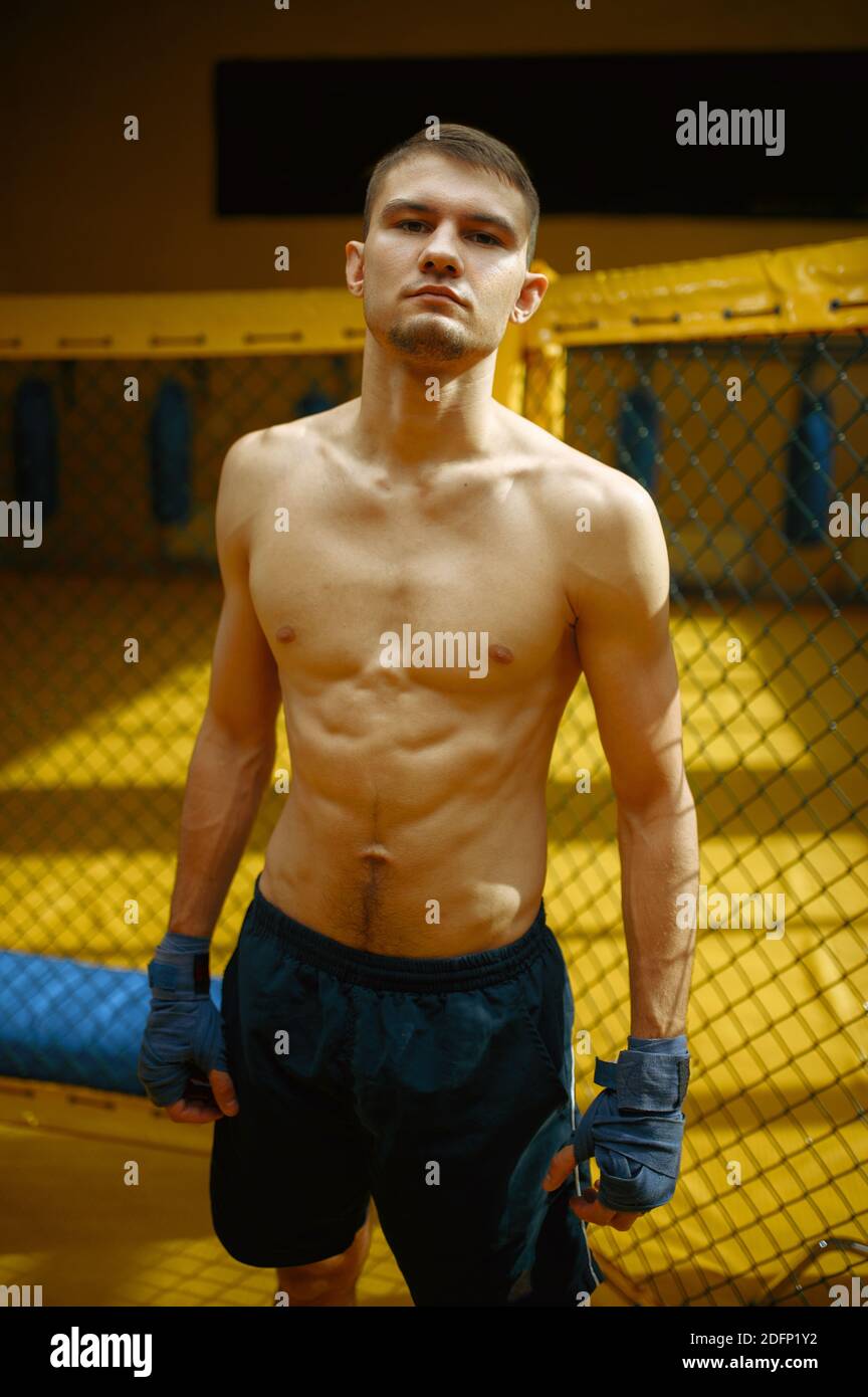 Male MMA fighter standing in a cage Stock Photo