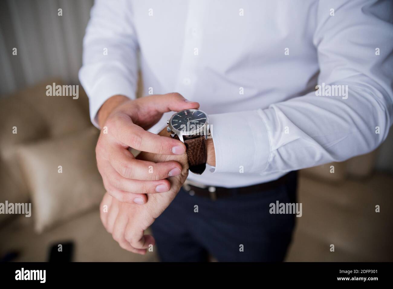 man puts a classic watch on his hand Stock Photo Alamy