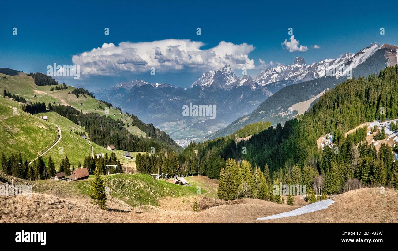 Swiss mountain scenery with blue sky and white clouds Stock Photo
