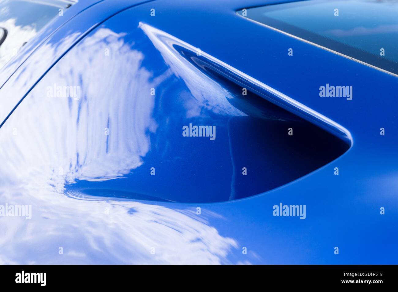 Close up detail of an engine intake duct on a metallic blue and white ...