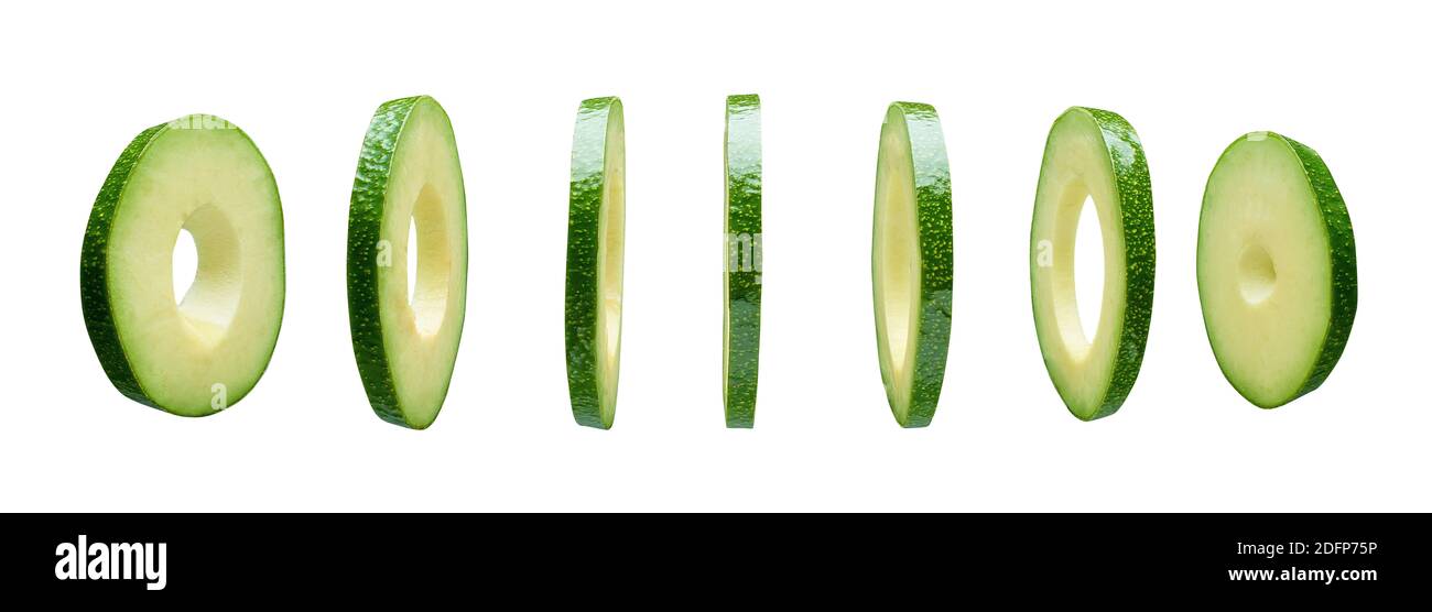 Avocado slices levitating in the air isolated on white background Stock Photo