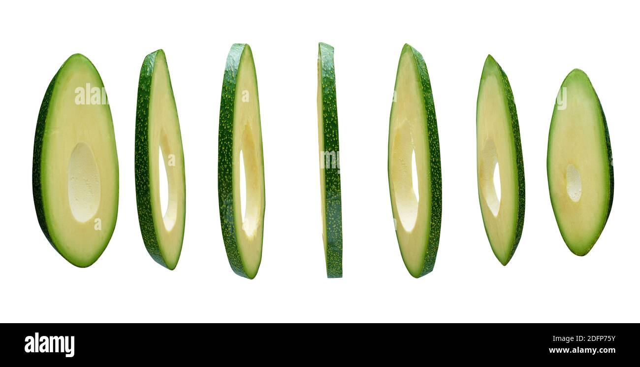 Avocado slices levitating in the air isolated on white background Stock Photo
