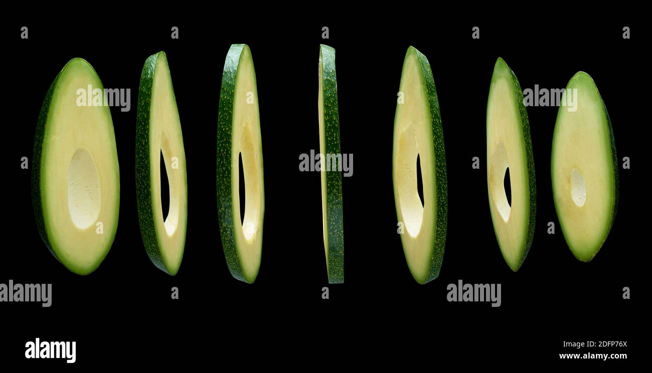 Avocado slices levitating in the air on black background Stock Photo