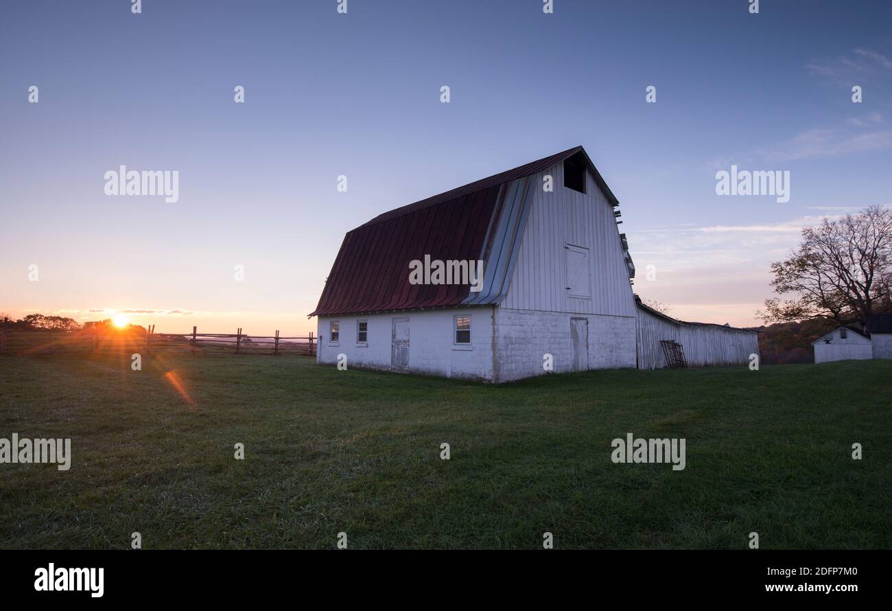 Sunrise over a barn at Sky Meadows State Park in Delaplane, Virginia in autumn. Stock Photo
