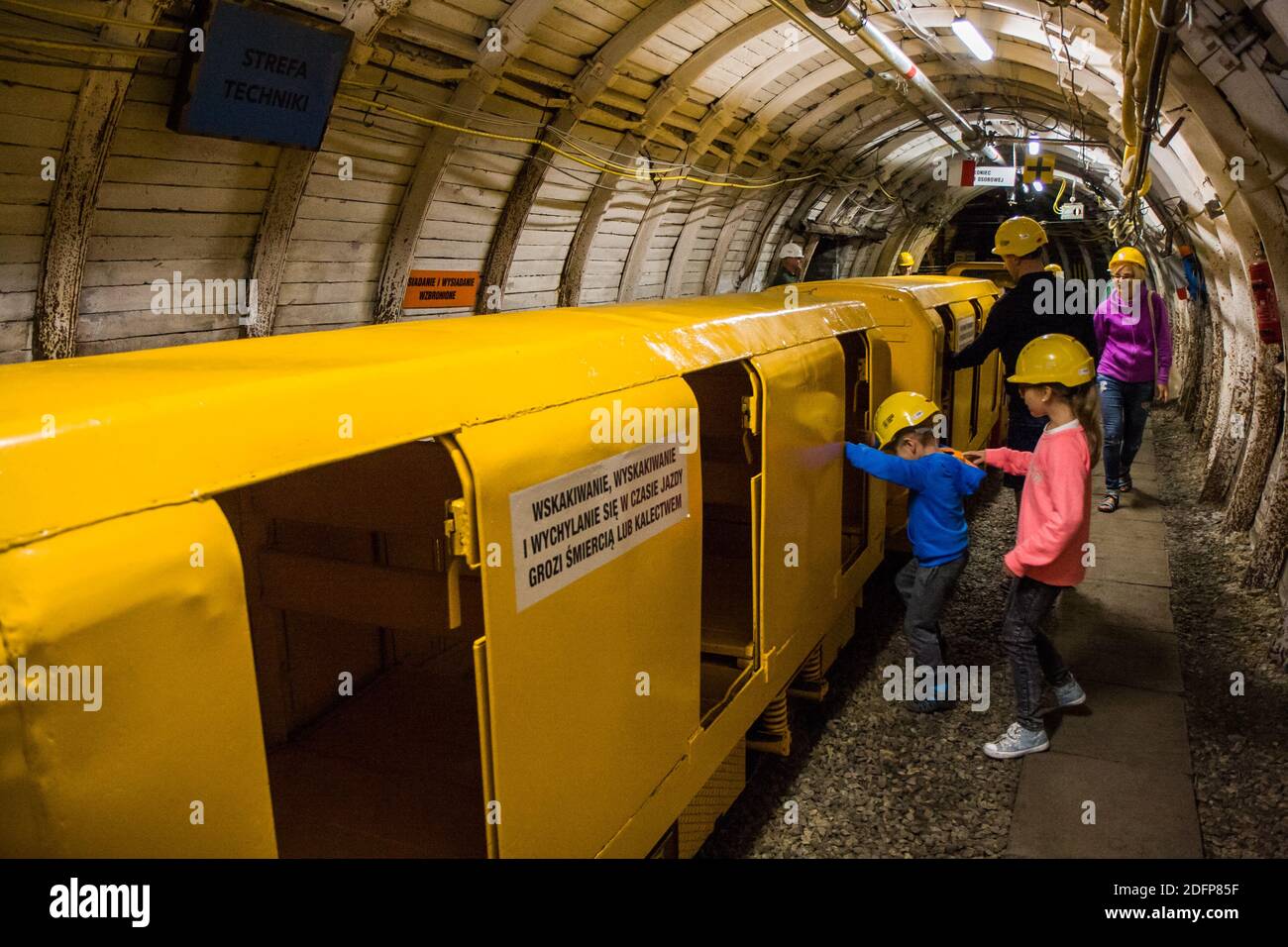 Ruda Śląska, Poland - July 16, 2017: Yellow wagons carry tourists in a tunnel at the coal mine. Stock Photo