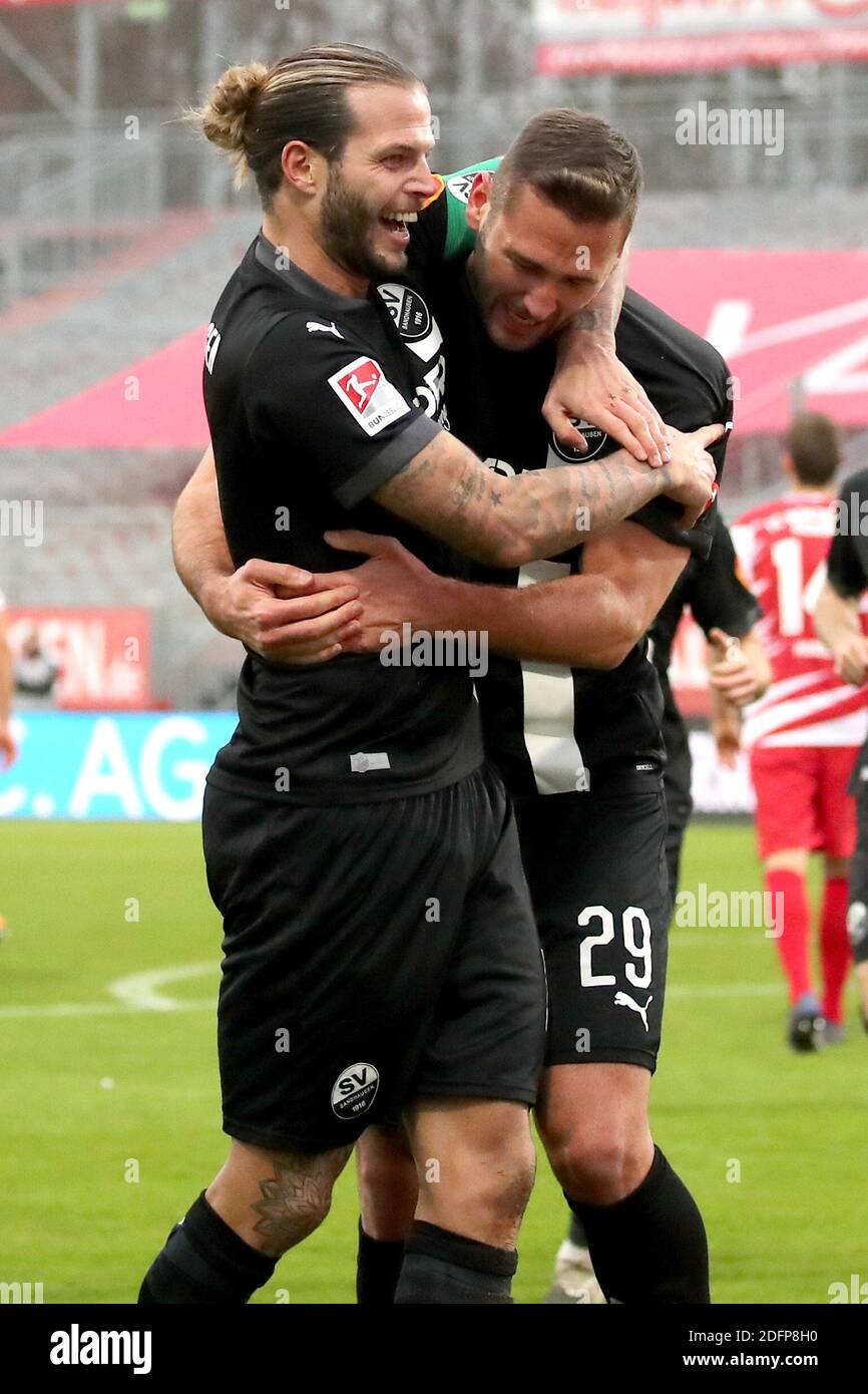 06 December 2020, Bavaria, Würzburg: Football: 2nd Bundesliga, Würzburger Kickers - SV Sandhausen, 10th matchday, in the Flyeralarm Arena. Ivan Paurevic from Sandhausen (r) cheers with his colleague Dennis Diekmeier about his goal for the 1:2. Photo: Daniel Karmann/dpa - IMPORTANT NOTE: In accordance with the regulations of the DFL Deutsche Fußball Liga and the DFB Deutscher Fußball-Bund, it is prohibited to exploit or have exploited in the stadium and/or from the game taken photographs in the form of sequence images and/or video-like photo series. Stock Photo