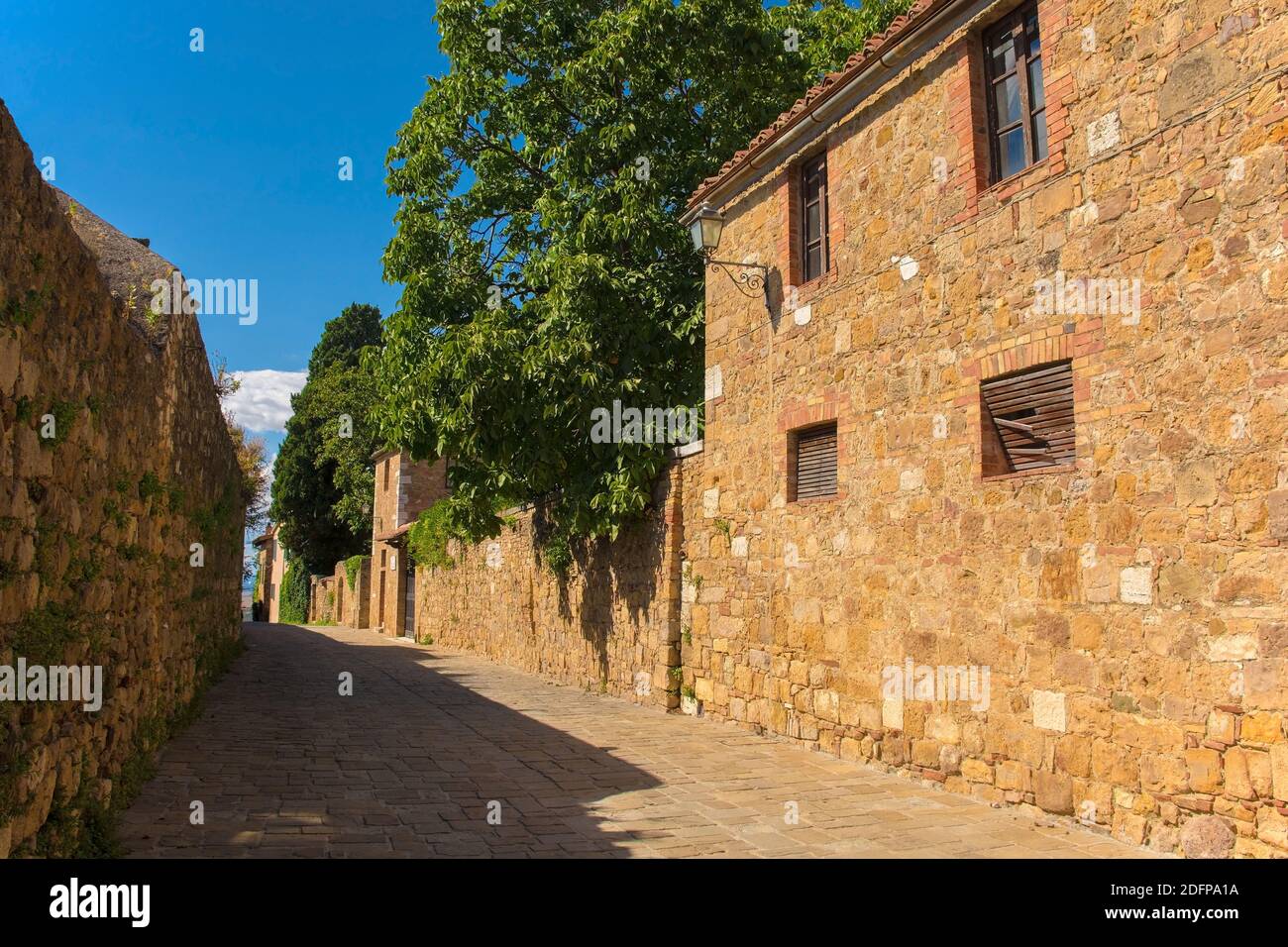 A residential road in the historic medieval village of San Quirico D'Orcia, Siena Province, Tuscany, Italy Stock Photo