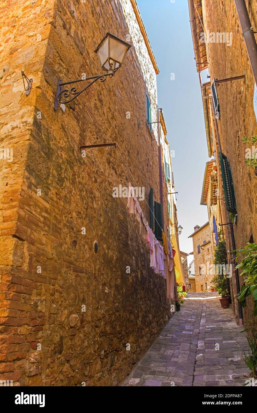A residential road in the historic medieval village of San Quirico D'Orcia, Siena Province, Tuscany, Italy Stock Photo