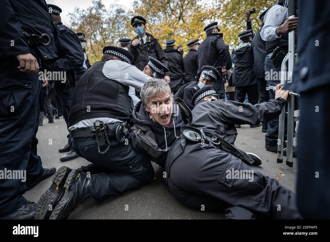 Heiko Khoo, a 35-year veteran speaker of Speakers’ Corner in Hyde Park, is arrested by police after scuffles during heckling with Tommy Robinson, UK. Stock Photo