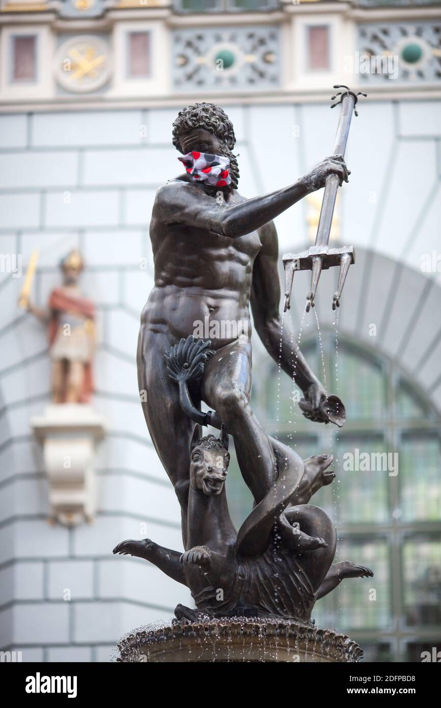 Gdank, Poland, May 24, 2020. Neptune - most famous place in Old Town in Gdansk - in Covid 19 mask Stock Photo
