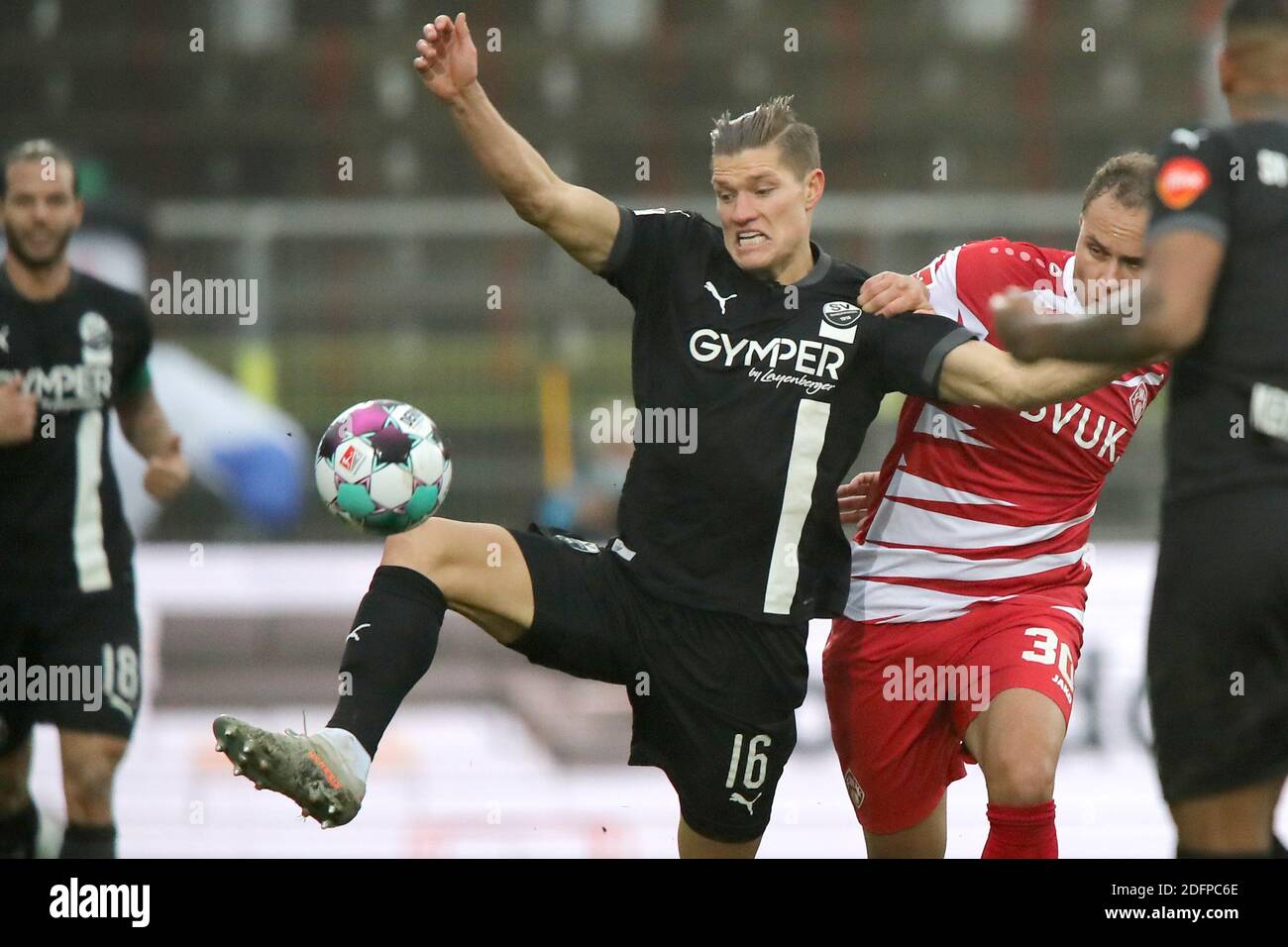 06 December 2020, Bavaria, Würzburg: Football: 2nd Bundesliga, Würzburger Kickers - SV Sandhausen, 10th matchday, in the Flyeralarm Arena. The Würzburger Ewerton (3rd from left) fights with Kevin Behrens (2nd from left) from Sandhausen for the ball. Photo: Daniel Karmann/dpa - IMPORTANT NOTE: In accordance with the regulations of the DFL Deutsche Fußball Liga and the DFB Deutscher Fußball-Bund, it is prohibited to exploit or have exploited in the stadium and/or from the game taken photographs in the form of sequence images and/or video-like photo series. Stock Photo