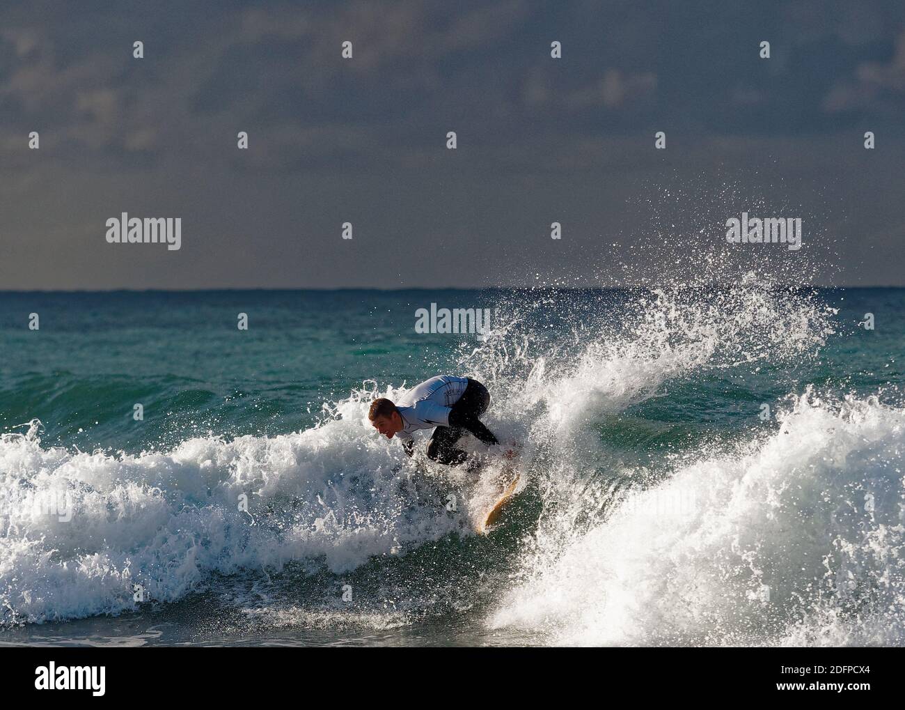 Newquay,Cornwall, 6th December 2020. UK weather, The Jet stream moves to give warm sunshine at the Lightning Bolt Single Fin shoot out surfing competition at Little Fistral beach, Collectors and enthusiasts brought vintage classic single fin Gerry Lopez surfboards to surf in Cornwall. Credit: Robert Taylor/Alamy Live News” Stock Photo