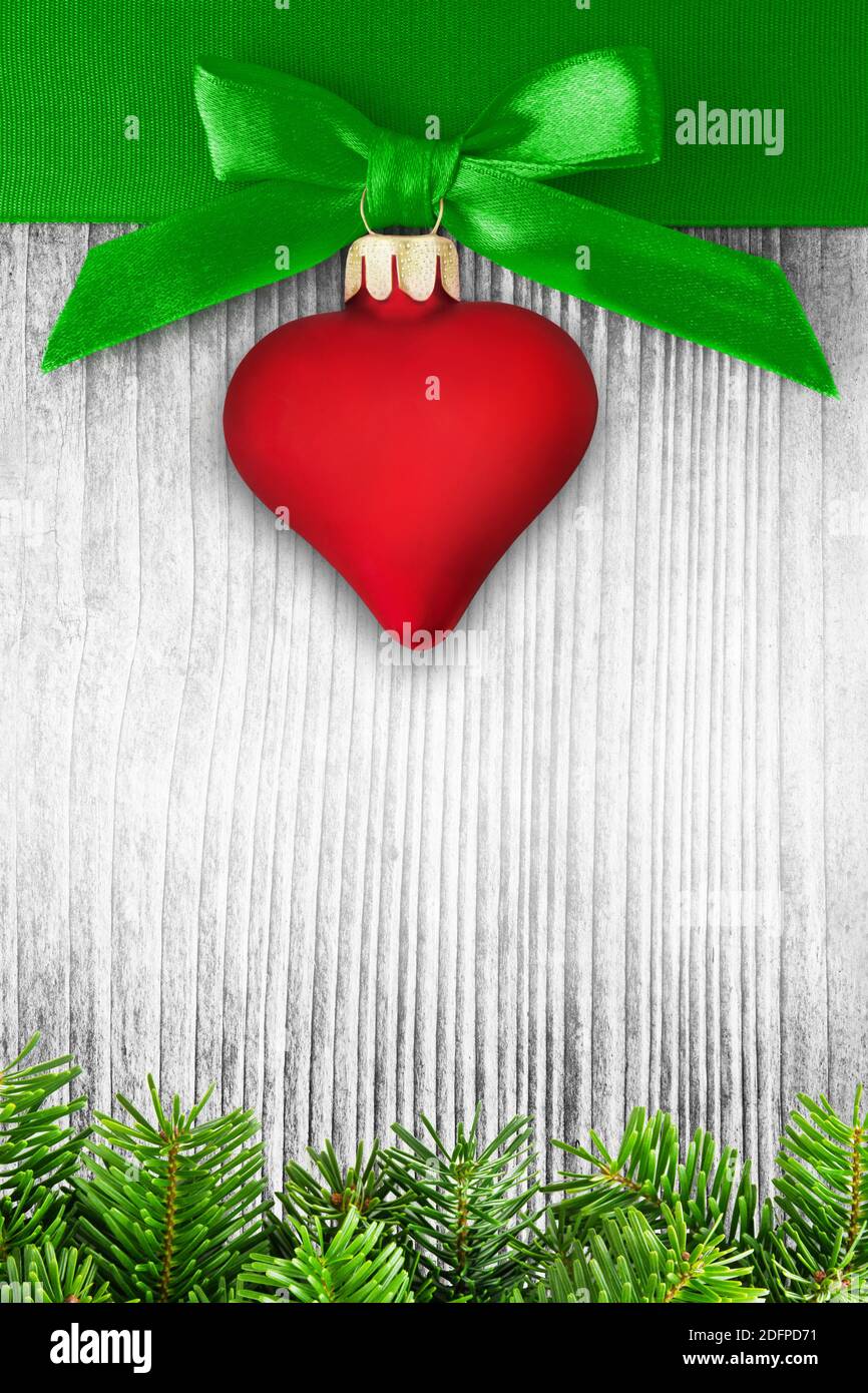 Red heart and Christmas decoration against wooden background Stock Photo