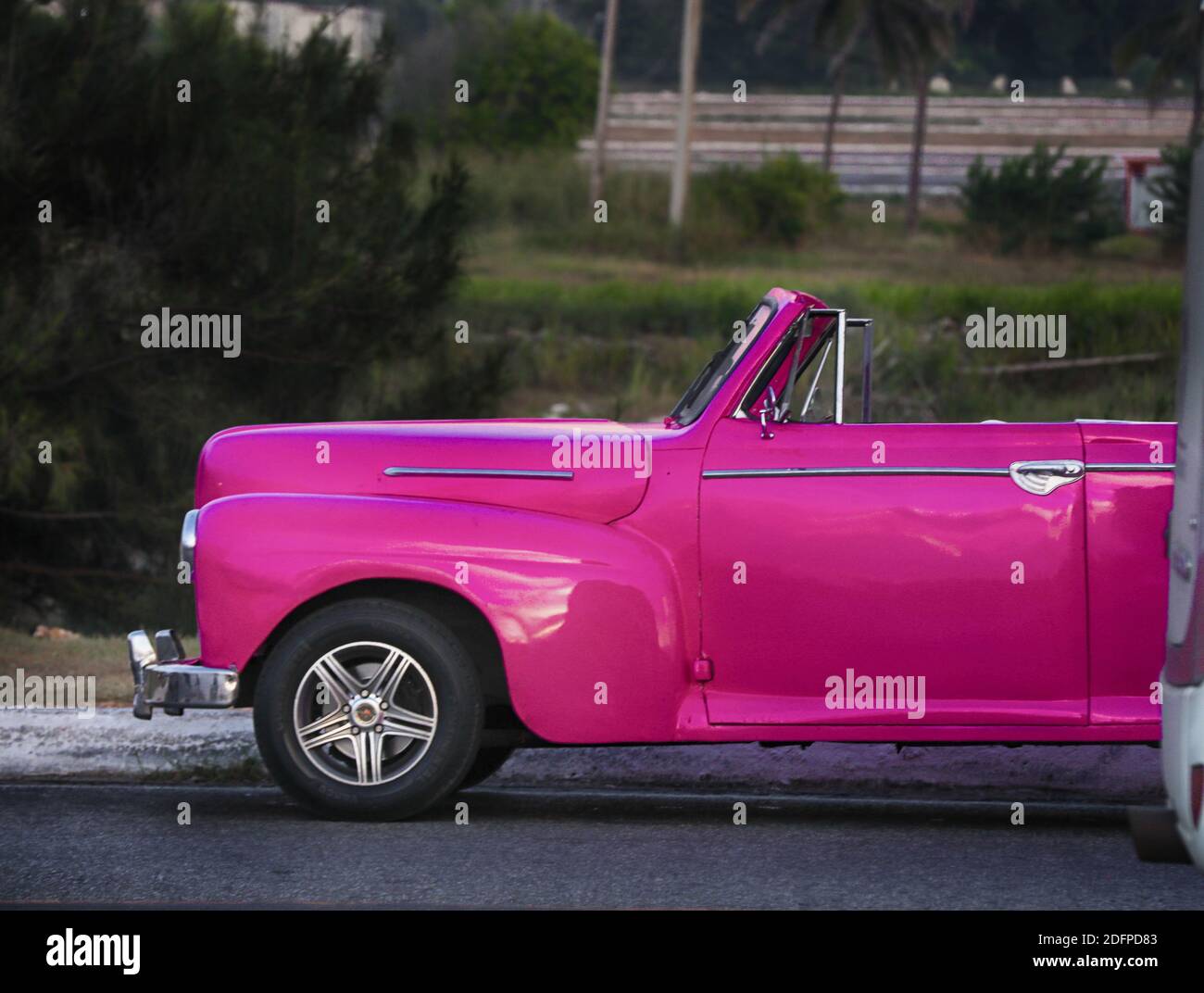 Old classic American maroon car rides, cubans could only trade cars ...