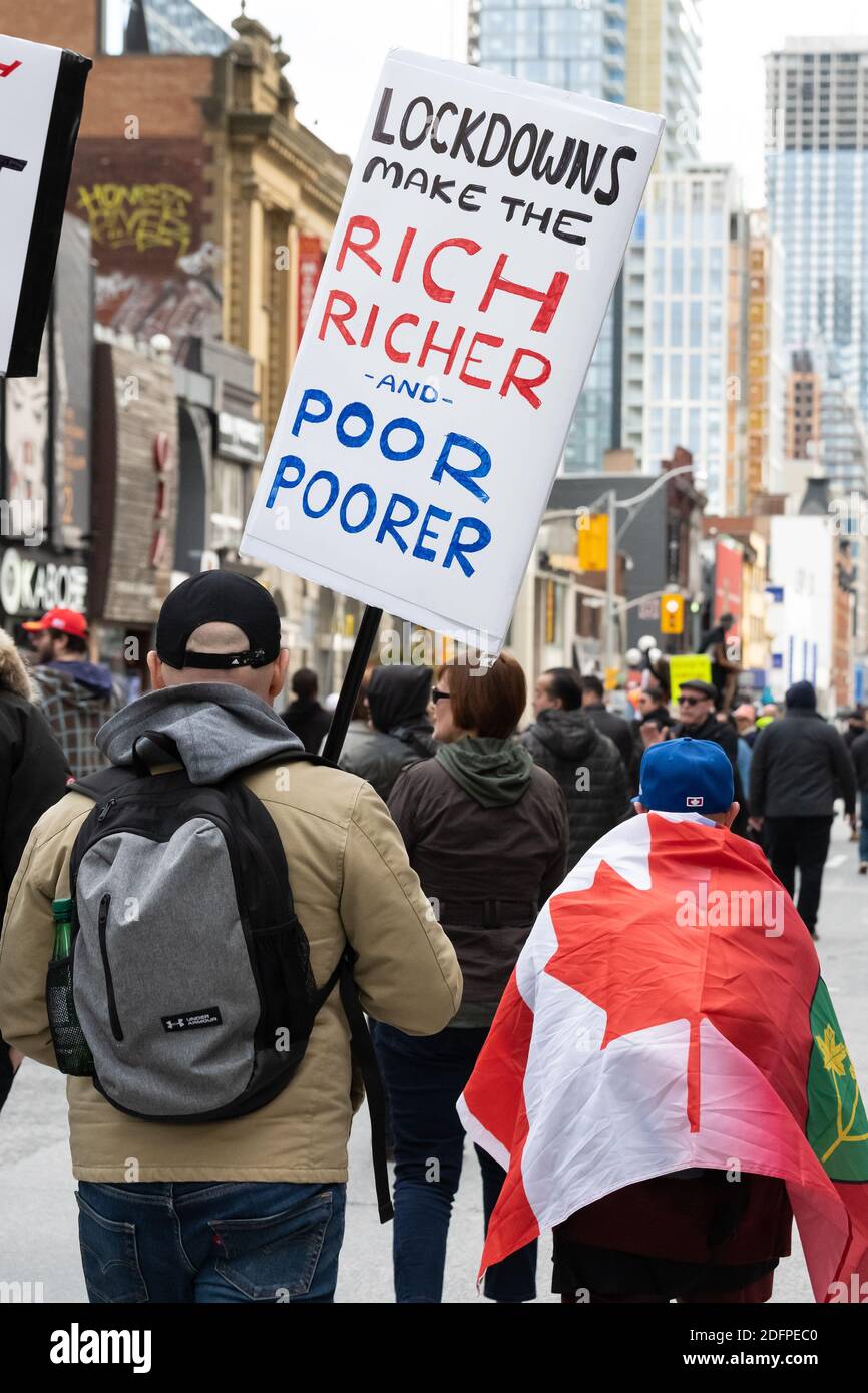 Anti-lockdown protesters in Toronto speak out about the effect COVID-19 lockdowns have on different demographics. Stock Photo
