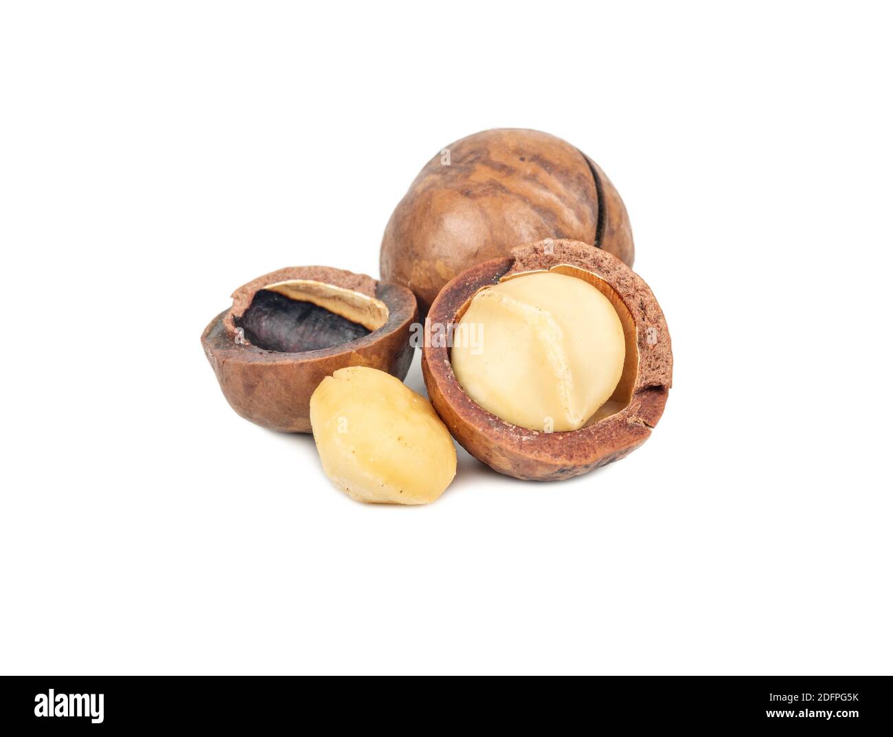Split macadamia nuts with whole ones on a white background Stock Photo