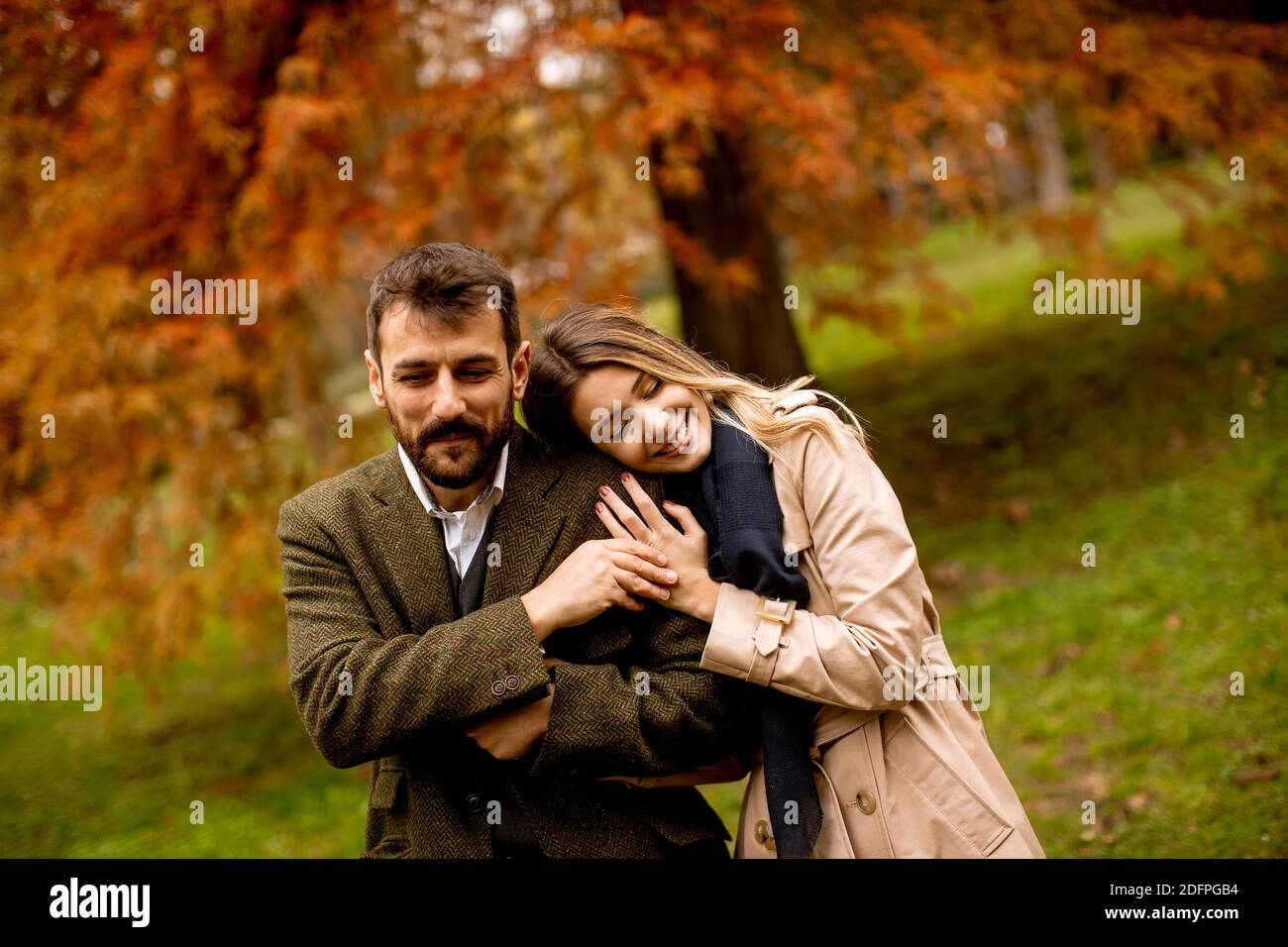 Handsome young couple in the autumn park Stock Photo - Alamy