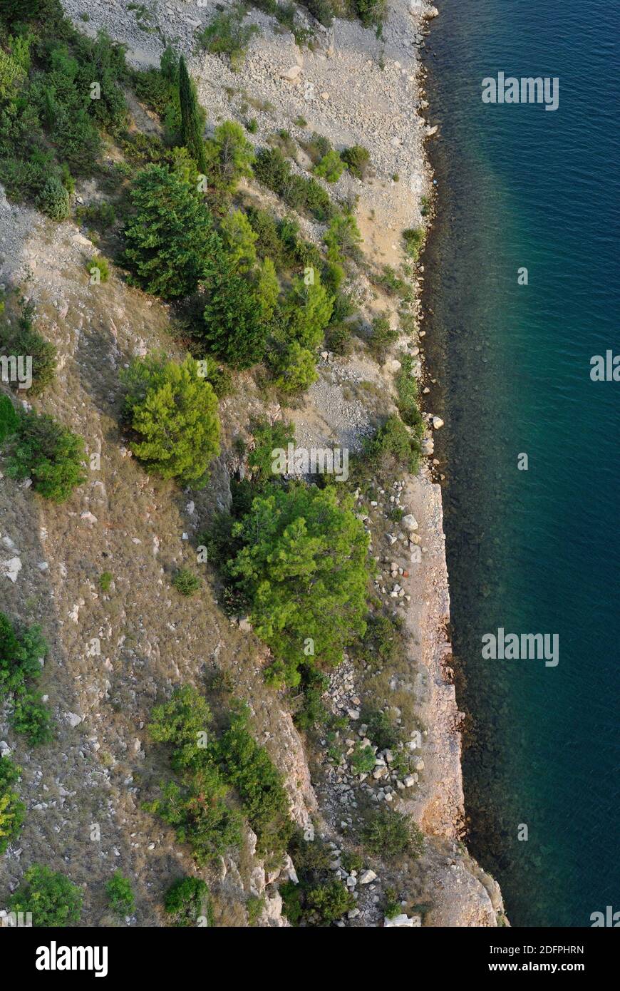 Stony beach in Croatia from above with blue green water Stock Photo