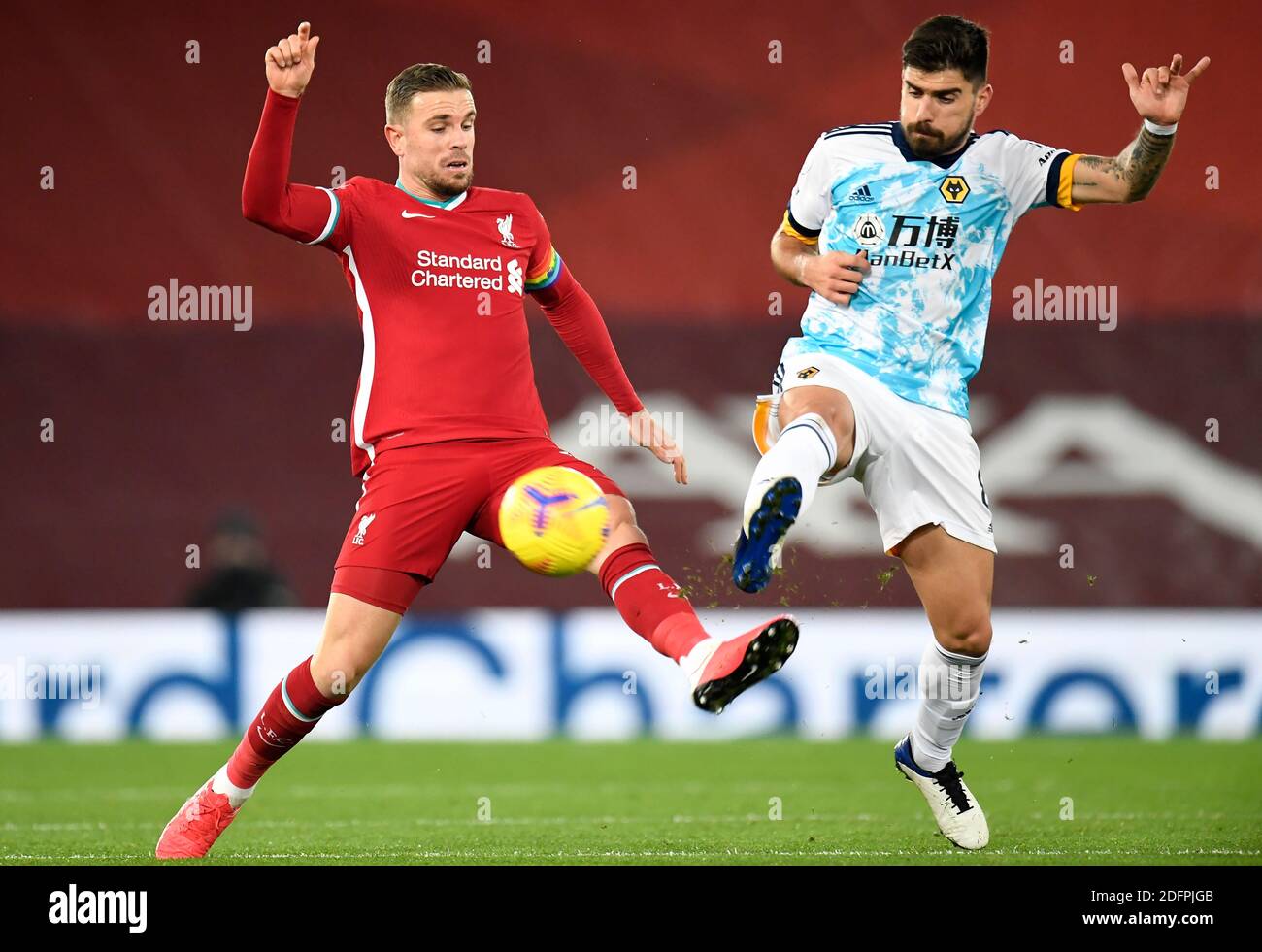 Liverpool's Jordan Henderson (left) and Wolverhampton Wanderers' Ruben Neves  battle for the ball during the Premier League match at Anfield, Liverpool  Stock Photo - Alamy
