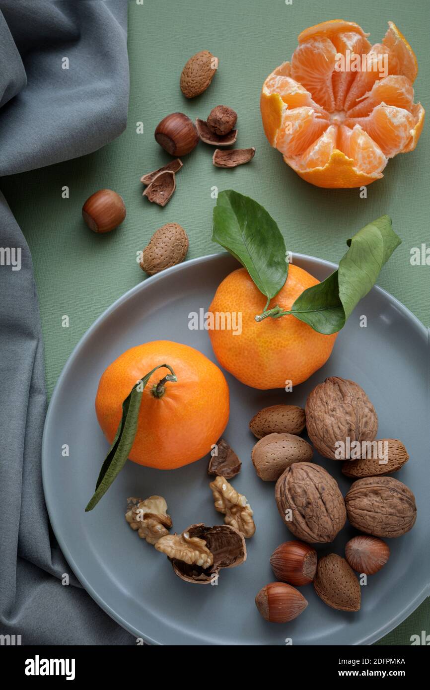 Easy peelers and mixed nuts from above Stock Photo