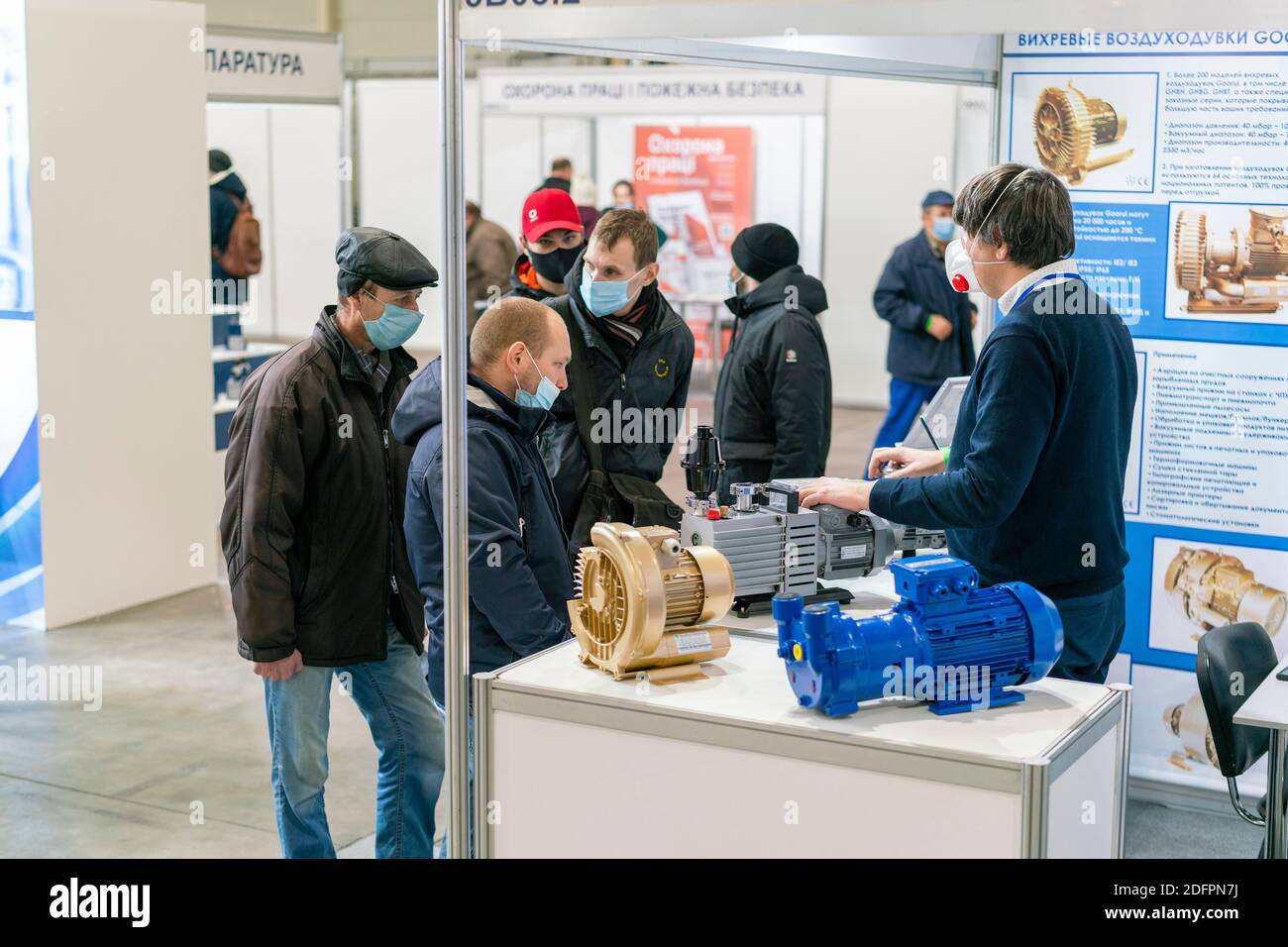 Kiev, Ukraine November 25 2020. Industrial Exhibition during a pandemic. People at the exhibition wearing medical masks. Exhibition and social Stock Photo