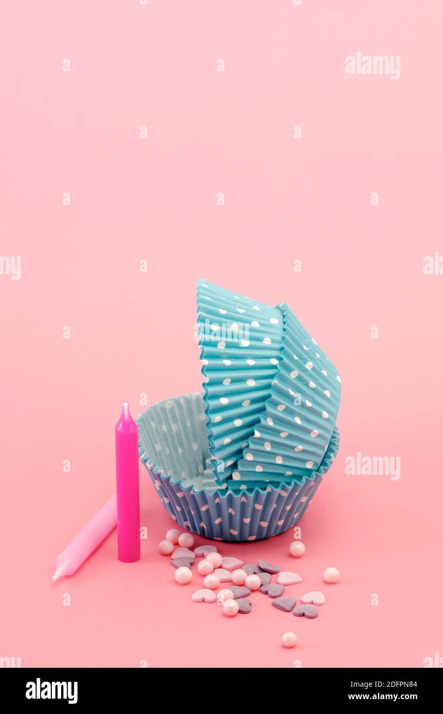 Blue paper cupcakes on pink background Stock Photo