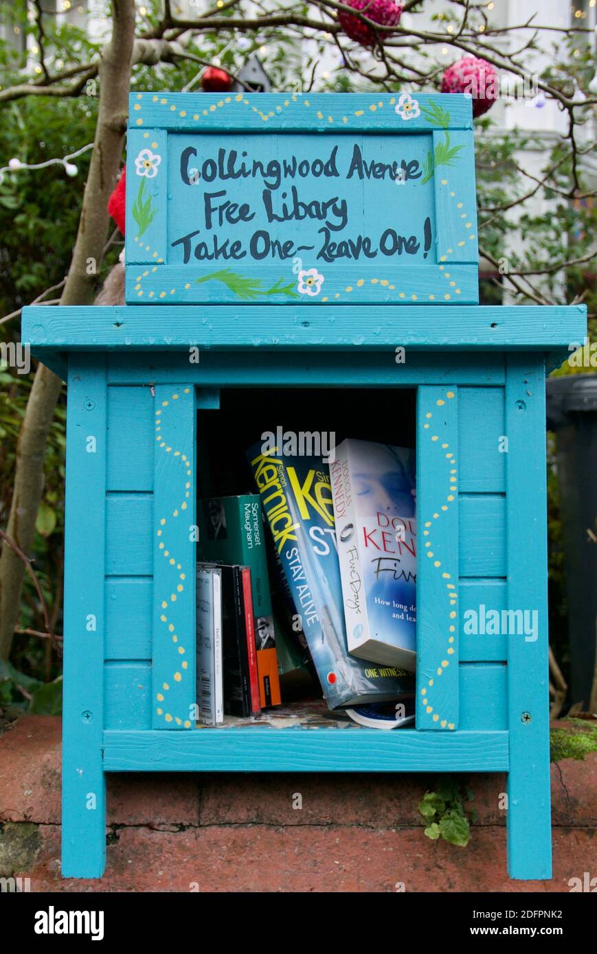 A public bookcase / Little Free Library in London. Book sharing scheme in local community to promote literacy and recycling / reusing books Stock Photo
