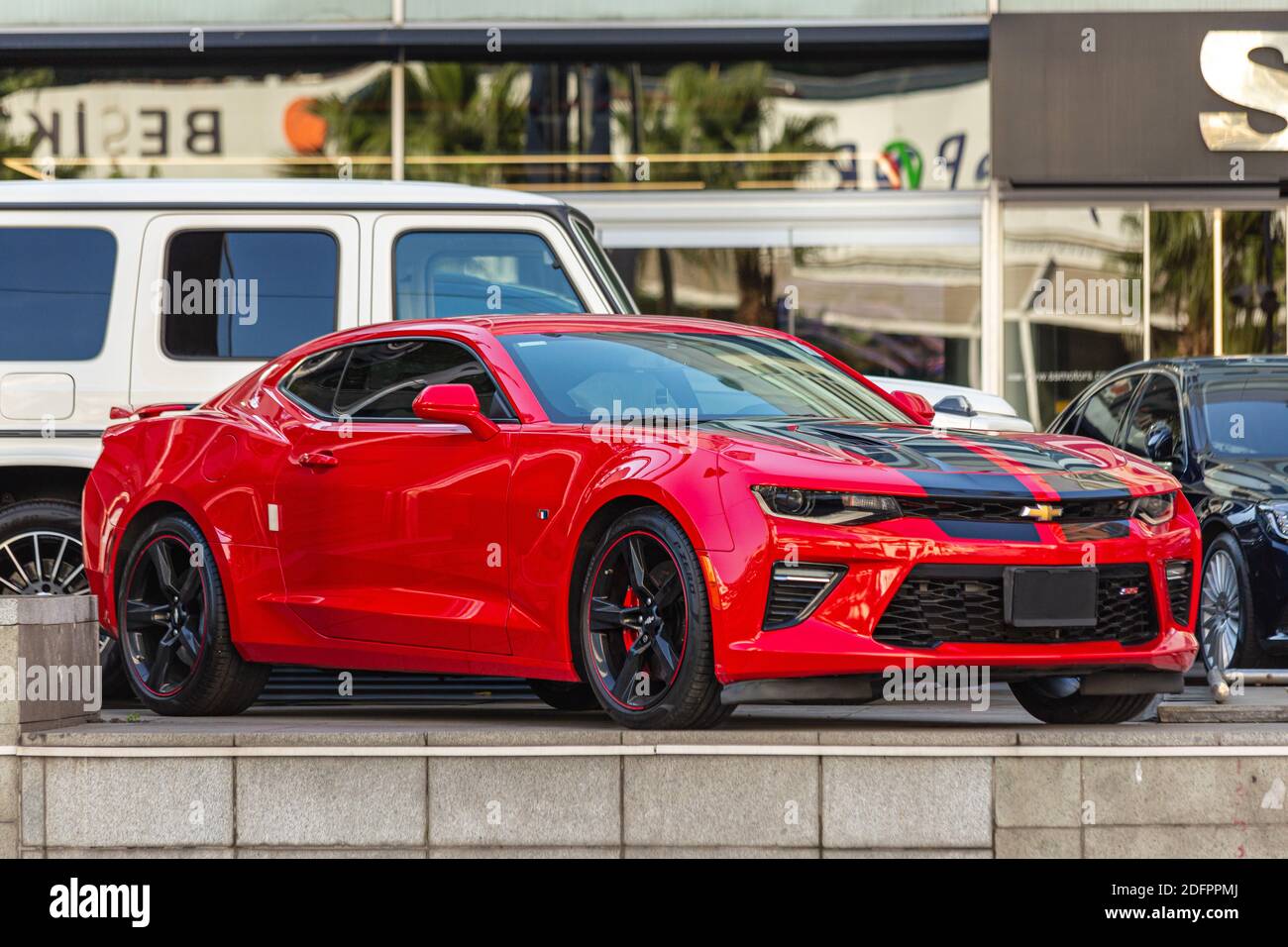 Red Chevrolet Camaro ZL1 supercharged muscle car with black stripe on the  hood. Side View Stock Photo - Alamy