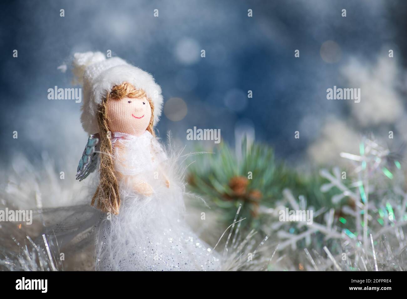 Toy angel and Christmas tree winter holiday festive background and ornaments Stock Photo